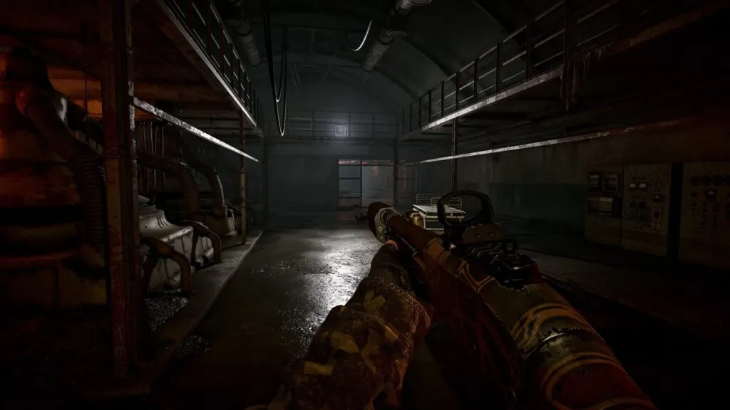 A dark industrial corridor with pipes and control panels in S.T.A.L.K.E.R. 2