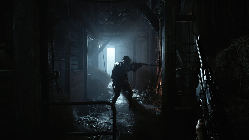 A hunter aiming down a dark corridor at a silhouette in a lit doorway in Hunt: Showdown