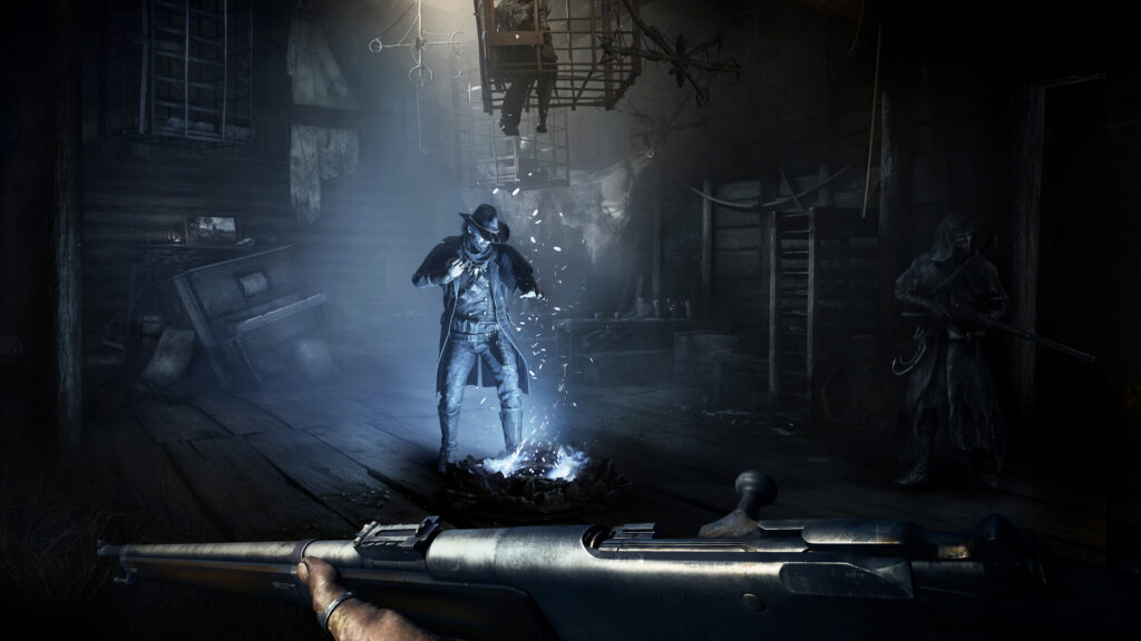 First person view along a rifle barrel toward two hunters in a dark barn in Hunt: Showdown