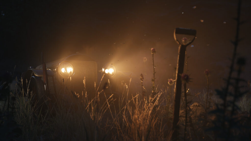 A car with headlights on in a night field and a shovel