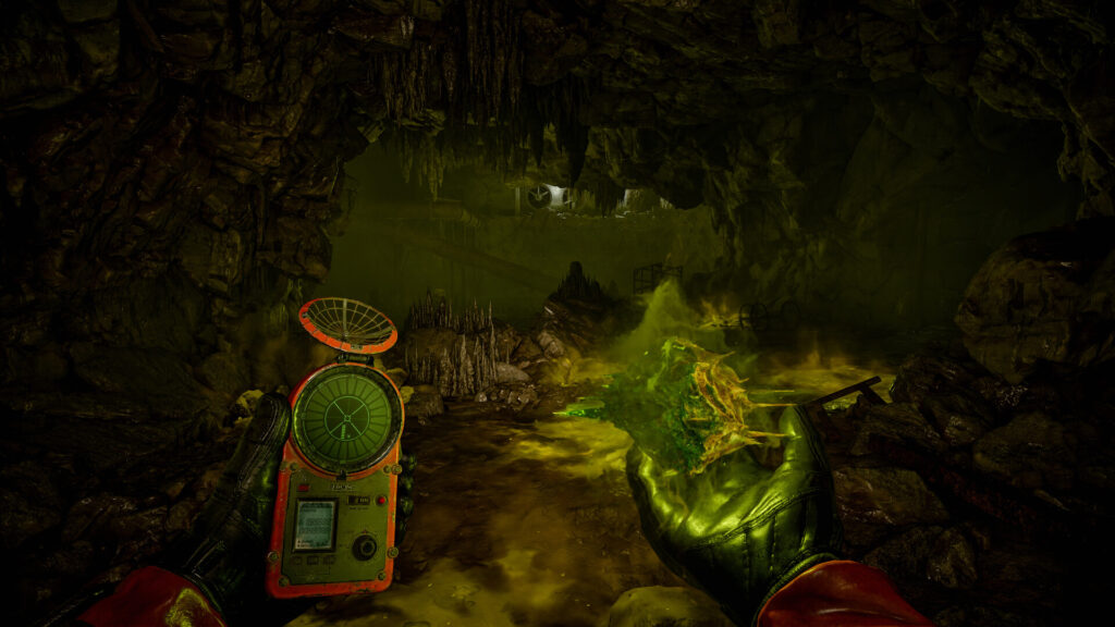 Green acid anomaly in a cave with an artifact detector held in hand