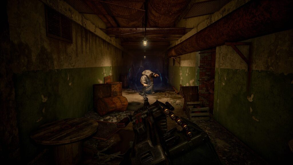 A mutant standing under a hanging lamp at the end of a derelict corridor in S.T.A.L.K.E.R. 2