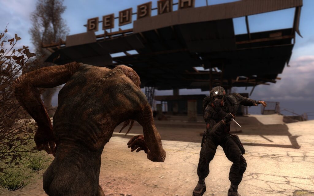 A stalker facing a chimera at a petrol station in S.T.A.L.K.E.R. Call of Pripyat