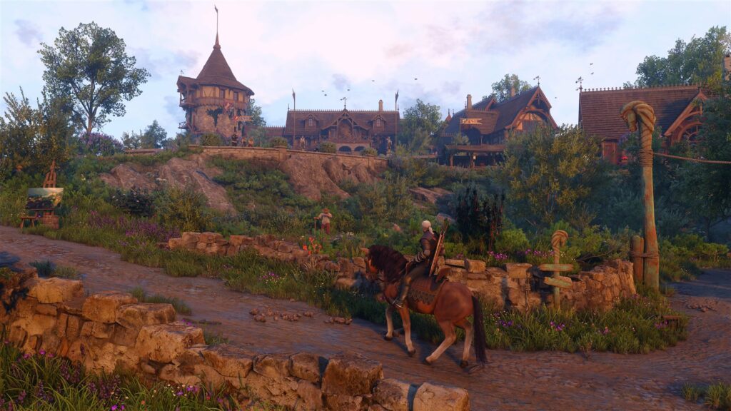 Geralt rides into a village in the new region of Letten in Songs of the Past