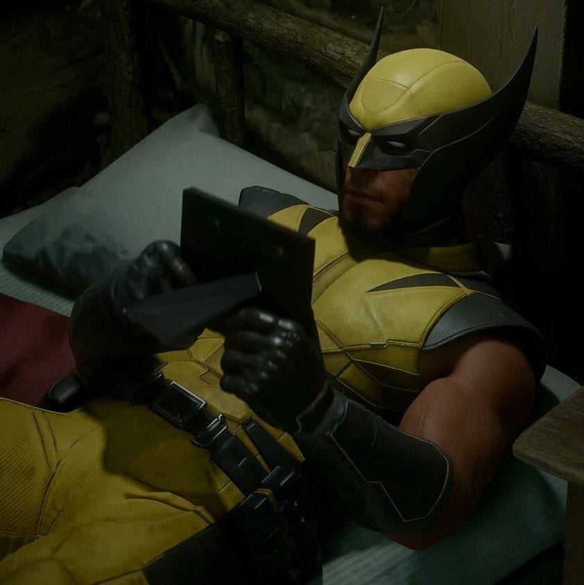 Wolverine lying on a bed looking at a picture frame, an in game screenshot