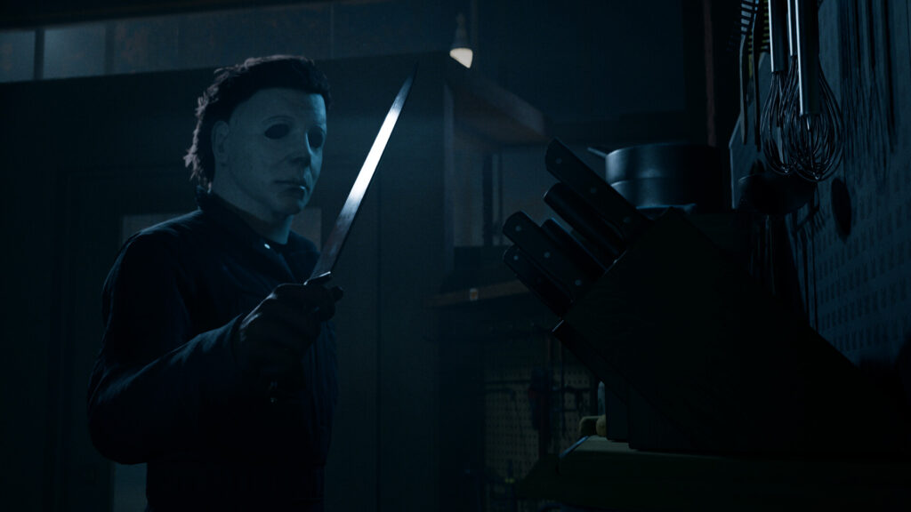 Michael Myers holding a kitchen knife in a dark kitchen