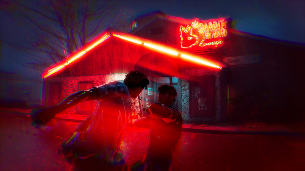 A fight outside a bar with a red neon sign