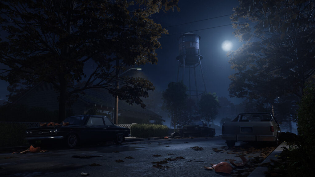A Haddonfield street at night with the water tower and the moon