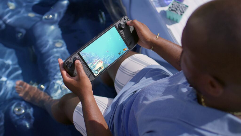 A Steam Deck OLED held in both hands, official Valve photo