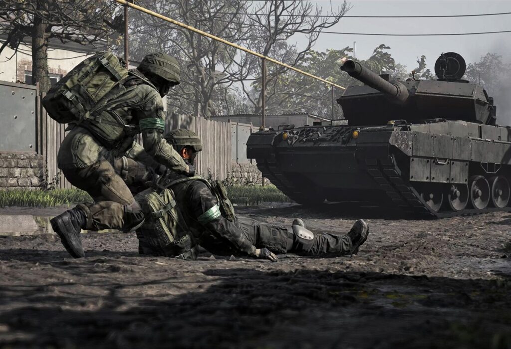 WARDOGS soldier dragging a wounded teammate near a tank