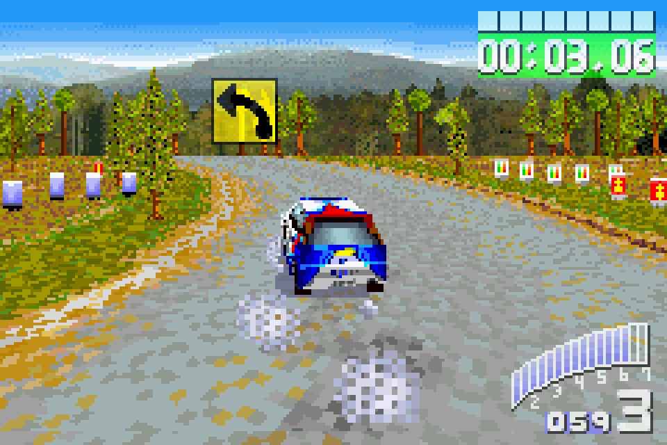 A pixel-art rally car takes a gravel corner, seen from behind, on Game Boy Advance