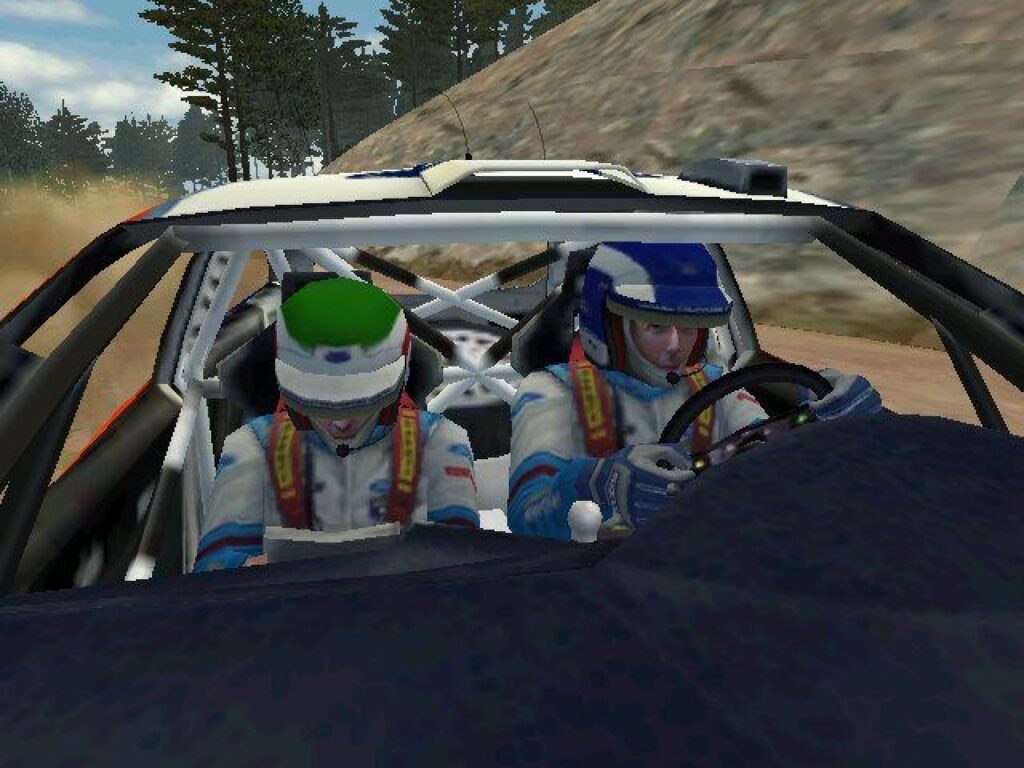 Inside a Ford Focus: two crew members in helmets, McRae at the wheel and Nicky Grist beside him