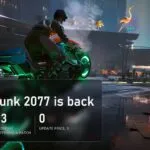 A motorbike with neon wheels on a Night City street in Cyberpunk 2077 with a plate about Update 2.5