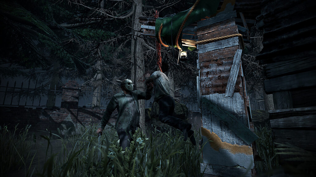 Jason carries a survivor to a hook between old sheds in a night forest