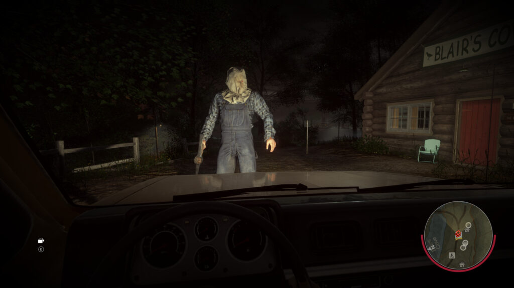 View from inside a car: Jason stands in the headlights outside Blair's cabin