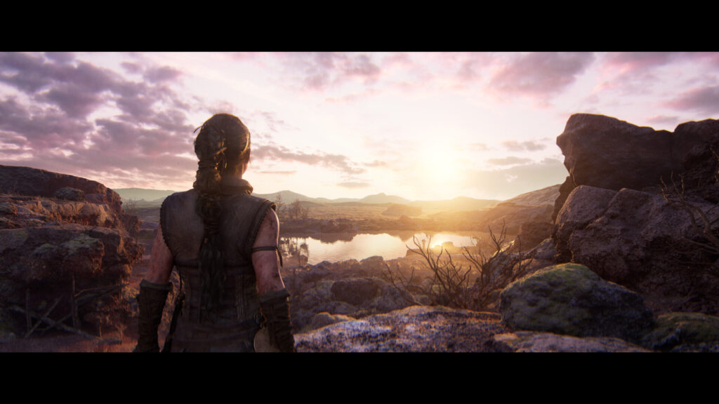 Сенуя смотрит на закат над скалами в Senua's Saga: Hellblade II
