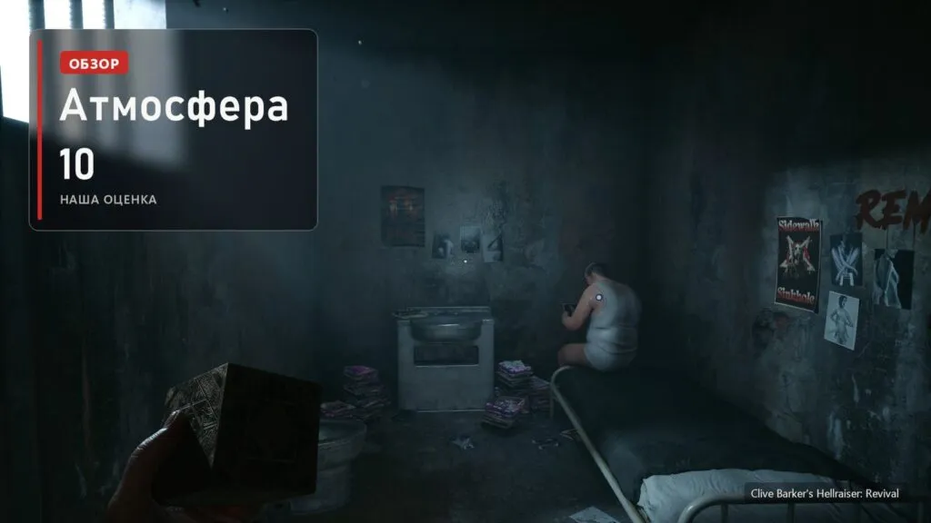Камера с решёткой на окне и сидящим человеком в Clive Barker's Hellraiser: Revival и плашка: атмосфера 10 из 10