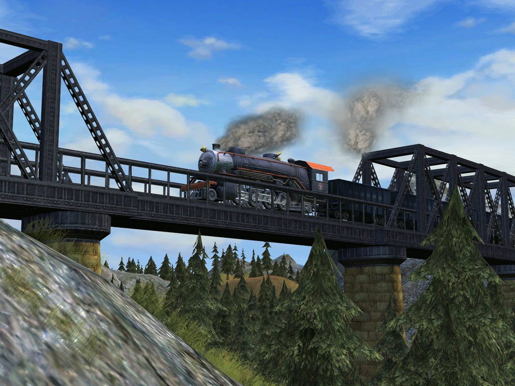 A steam locomotive pulls carriages over a steel bridge between wooded hills, from Sid Meier's Railroads!